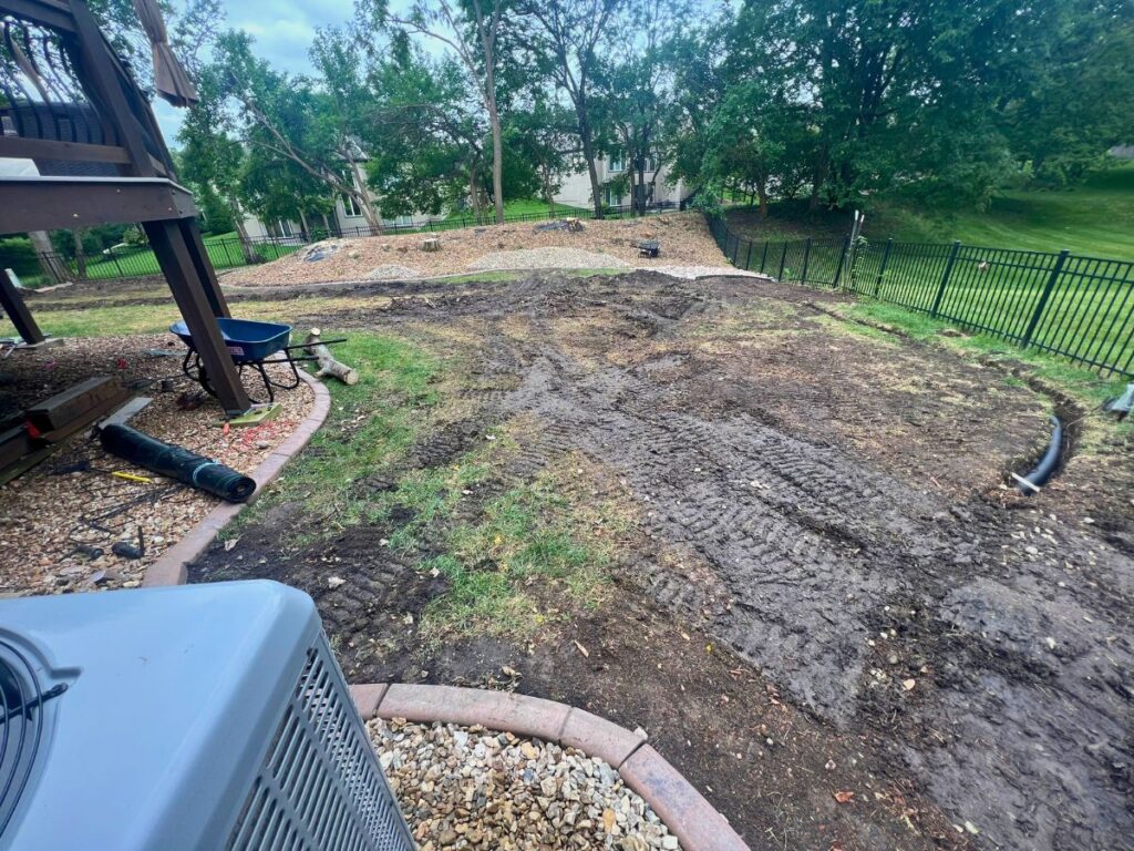 A graded patch of dirt in a backyard.